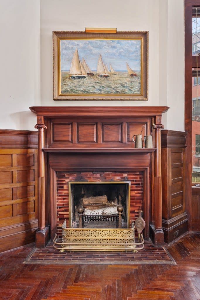 A fireplace with mahogany detail. Platinum Forbes Global Properties