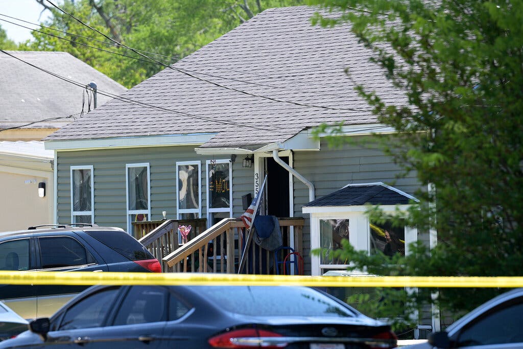 A home cordoned off by yellow police tape.