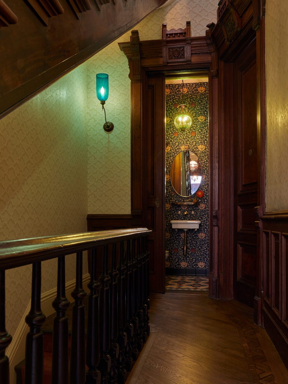Victorian-style hallway with ornate wooden features and a bathroom entrance.