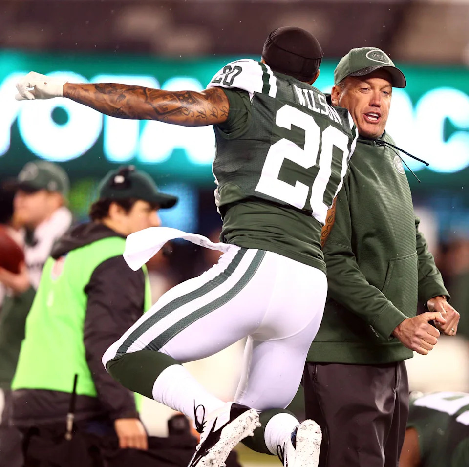 New York Jets head coach Rex Ryan and New York Jets cornerback Kyle Wilson (20) during warmups before a game against the Miami Dolphins at MetLife Stadium.