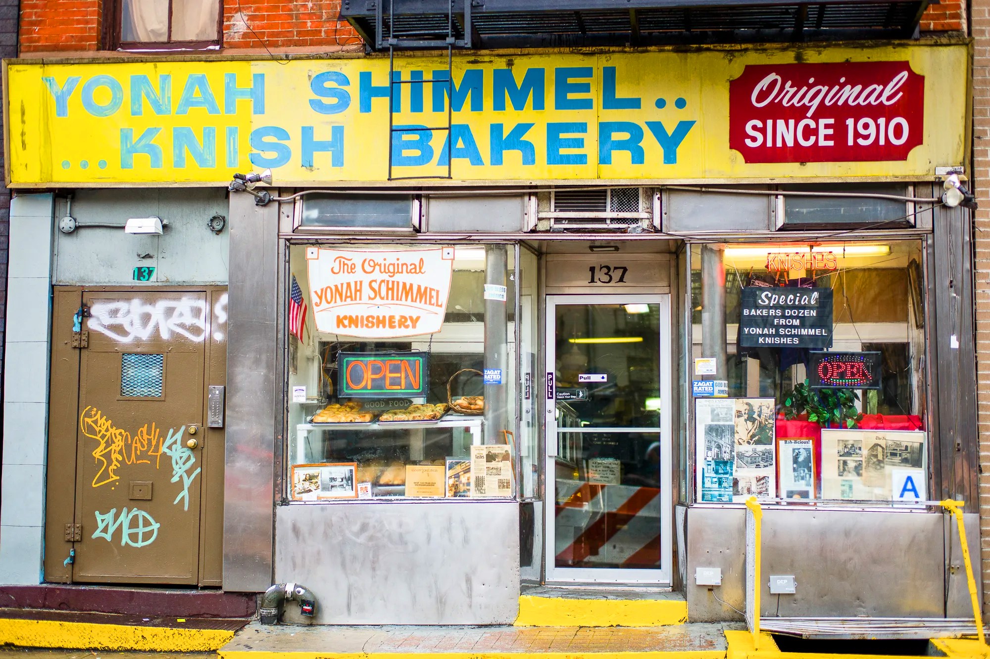 A storefront advertising knishes with bright signage.