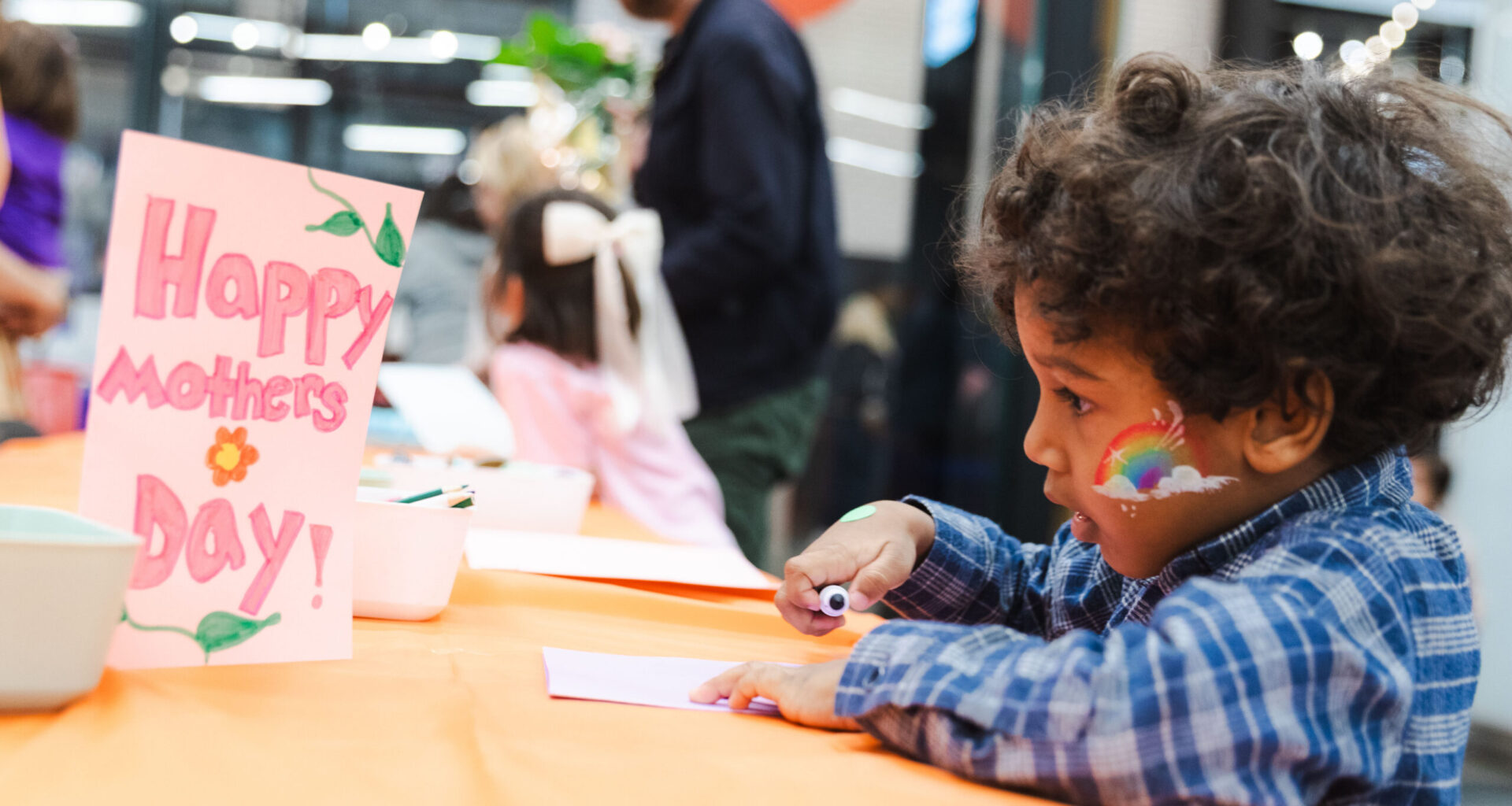 A young guest at last year’s festival makes a card for his mom. Photo: Brooklyn Org.