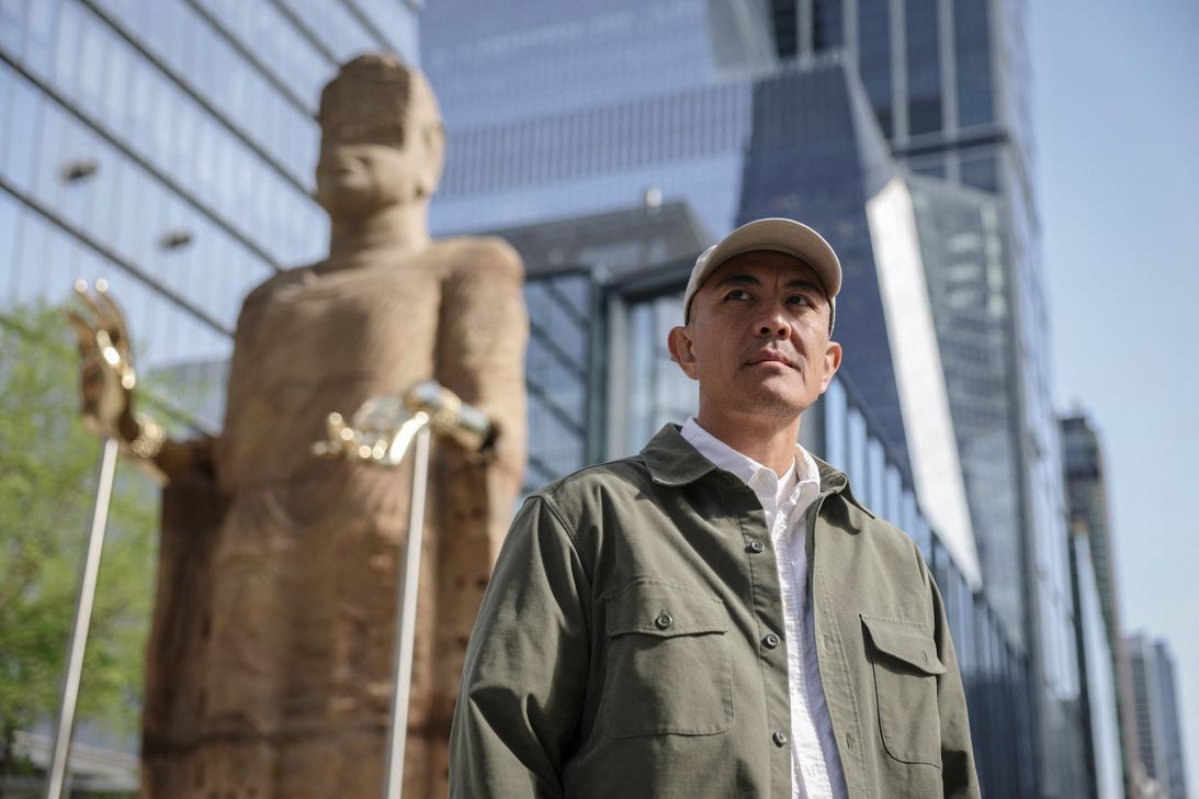Vietnamese American artist Tuan Andrew Nguyen, who lives and works in Ho Chi Minh City, pictured beside his artwork in New York on Friday.