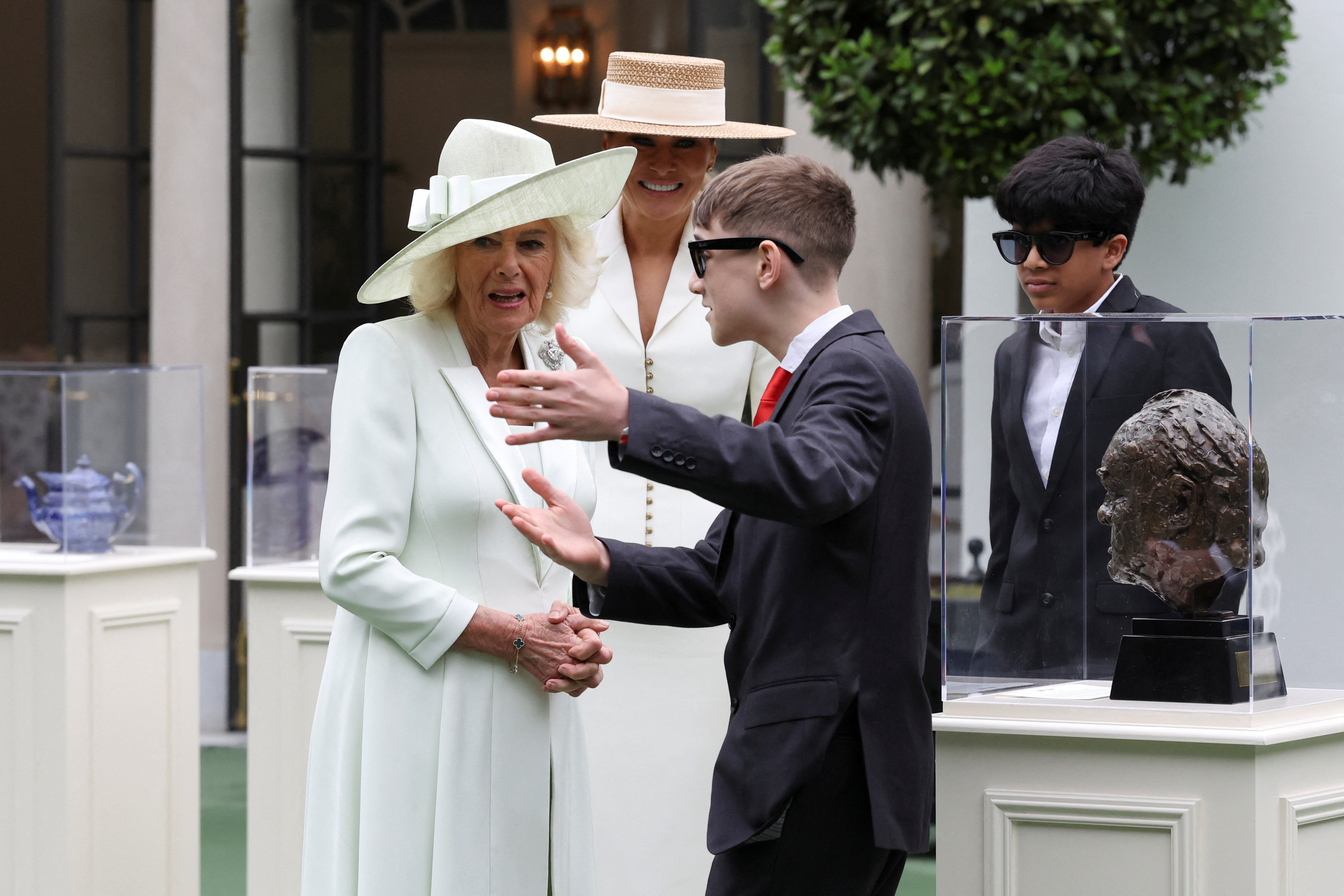 Melania Trump and Queen Camilla watch students using AI-enabled glasses as they take part in a cultural educational event ay the White House Tennis Pavilion.