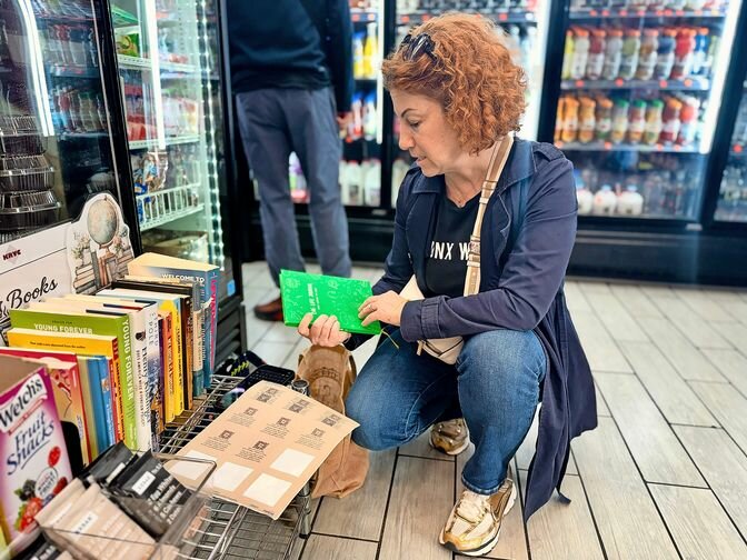A small shelf of free books sits between everyday items inside a Bronx bodega as part of the &ldquo;BooksxBodegas&rdquo; initiative, which aims to bring reading into spaces residents visit daily.