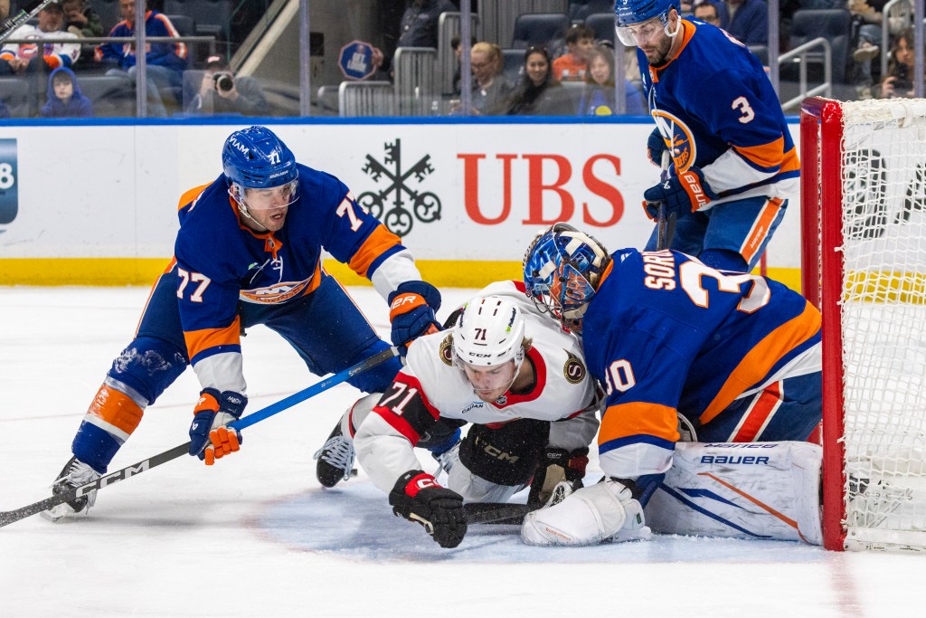 New York Islanders defenseman Tony DeAngelo (77) checks Ottawa Senators center Ridly Greig (71) during the second period at UBS Arena, Saturday, April 11, 2026, in Elmont, NY. 
