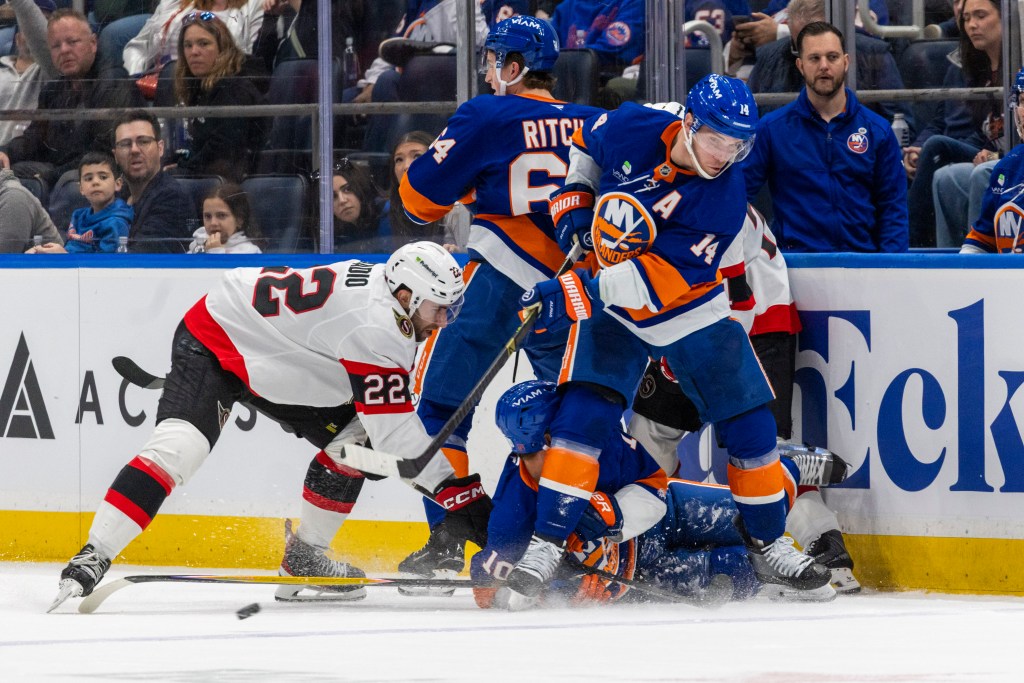 New York Islanders center Bo Horvat (14) crosses the puck during the second period against the Ottawa Senators at UBS Arena, Saturday, April 11, 2026, in Elmont, NY.