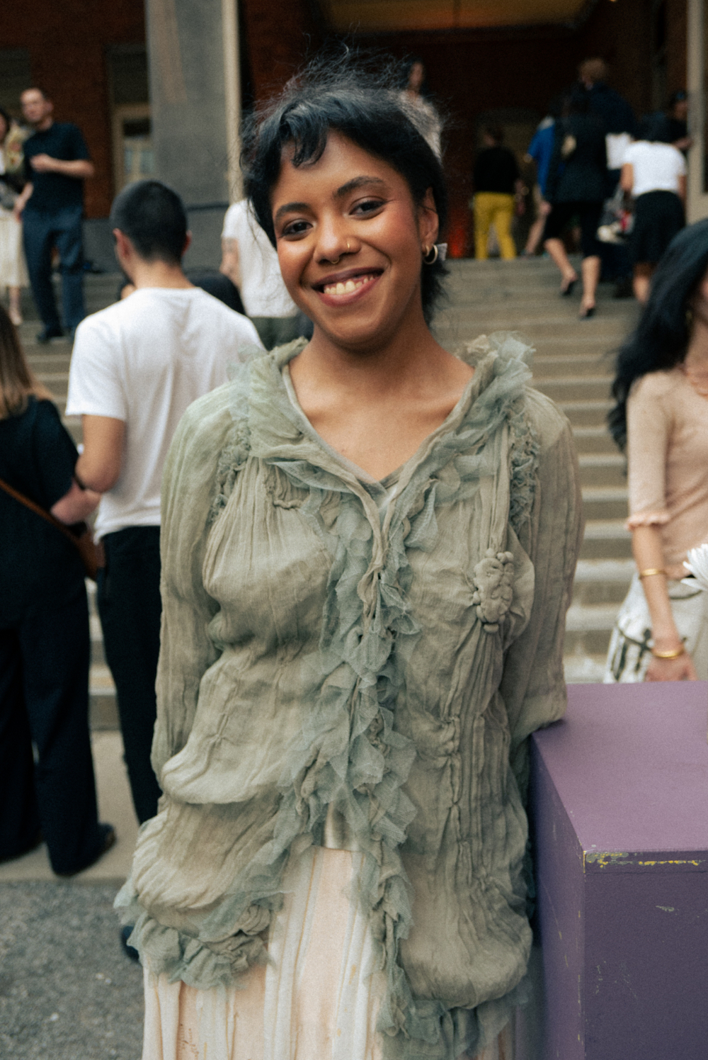 Taína Cruz in a ruffled green top at MoMA PS1 exhibition