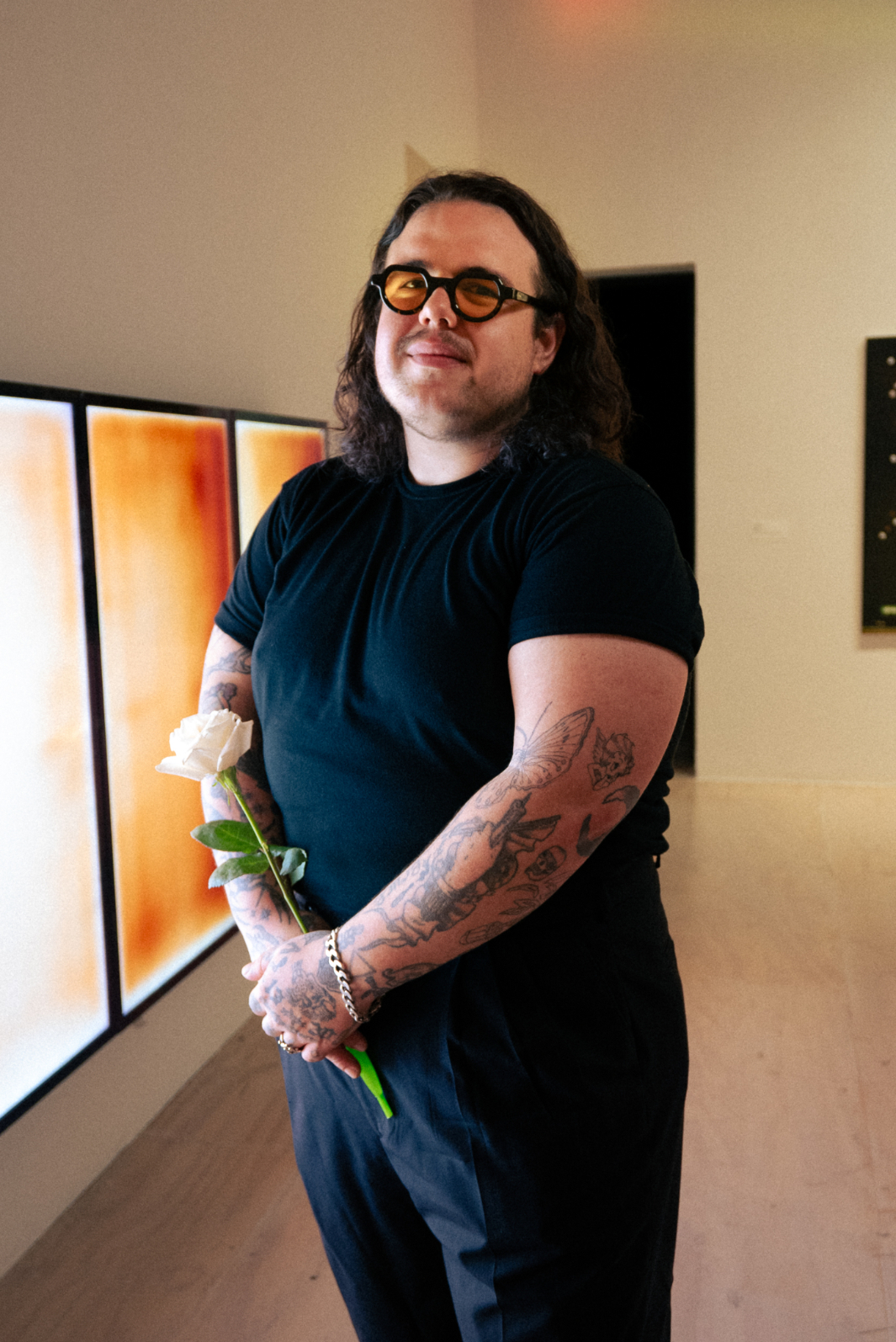 André Magaña standing with a rose.