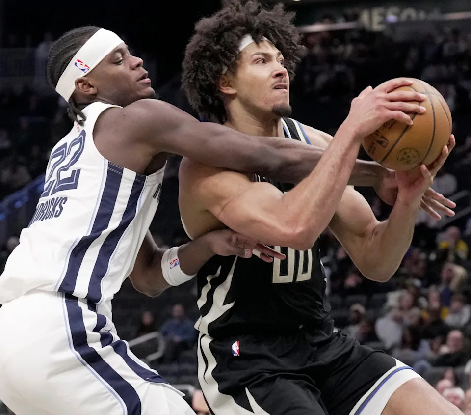 Memphis Grizzlies forward Taylor Hendricks (22) fouls Milwaukee Bucks center Jericho Sims (00) during the second half of their game Sunday, April 5, 2026 at Fiserv Forum in Milwaukee, Wisconsin. The Milwaukee Bucks beat the Memphis Grizzlies 131-115.