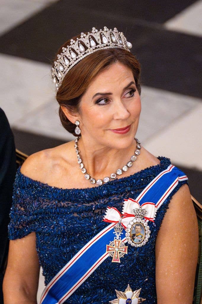 Queen Mary sat down in blue dress and tiara