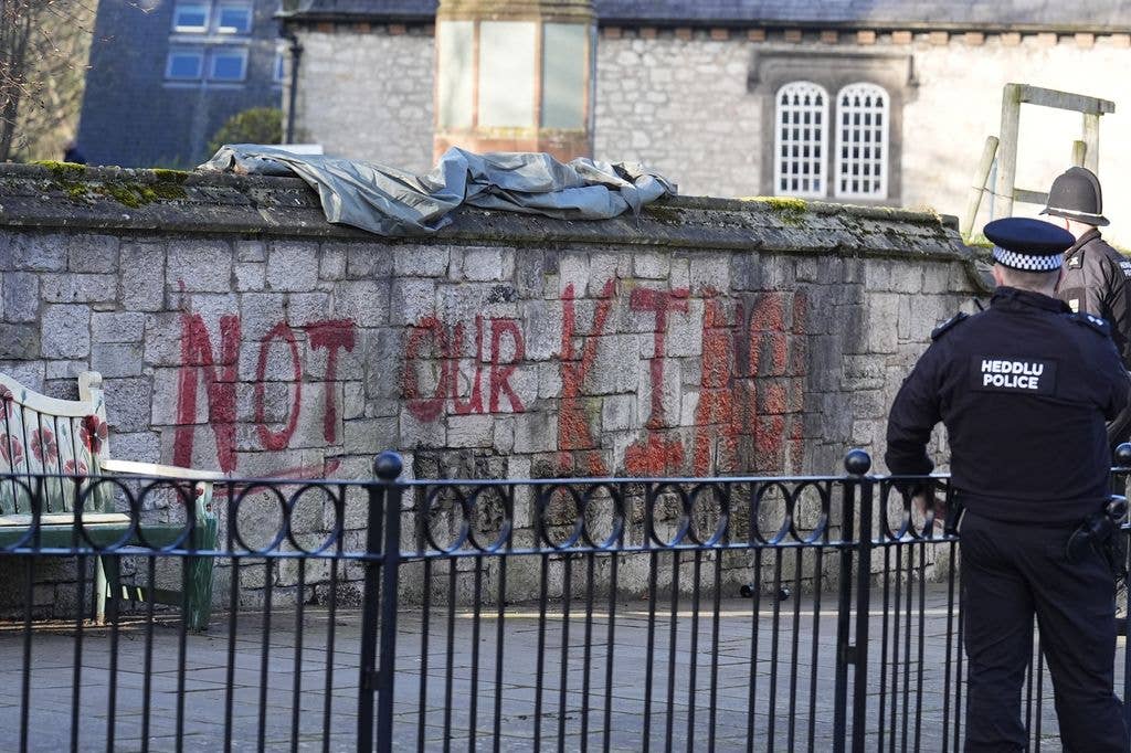 Spray painted graffiti which says "Not My King" on the wall outside St Asaph Cathedral in North Wales