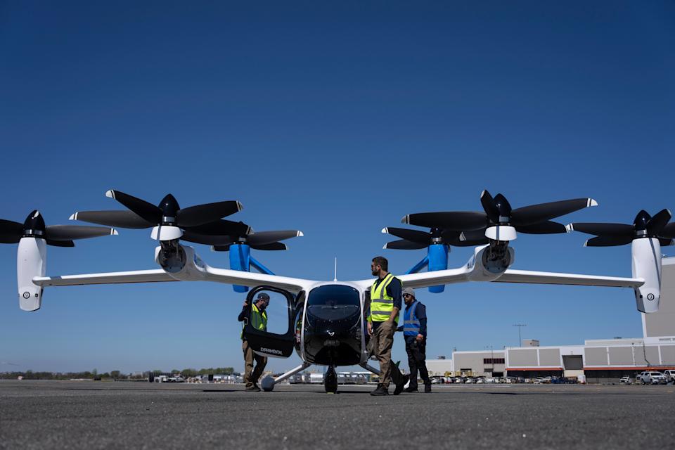People prepare an electric vertical take-off and landing (eVTOL) aircraft by Joby Aviation at the John F. Kennedy International Airport, Monday, April 27, 2026, in New York. (AP Photo/Yuki Iwamura)