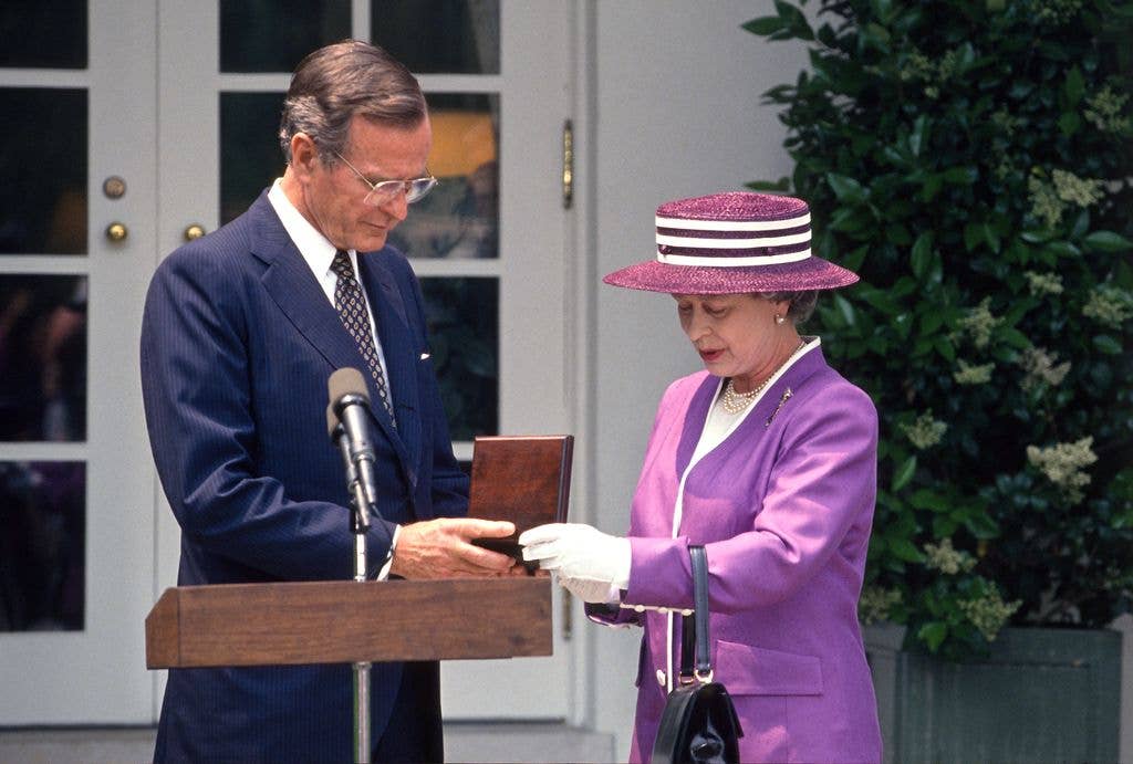 US President George HW Bush (1925 - 2018) (left) receives the Churchill Award from British monarch Queen Elizabeth II during an event in the White House's Rose Garden, Washington DC, May 14, 1991. (Photo by Arnie Sachs/CNP/Getty Images)