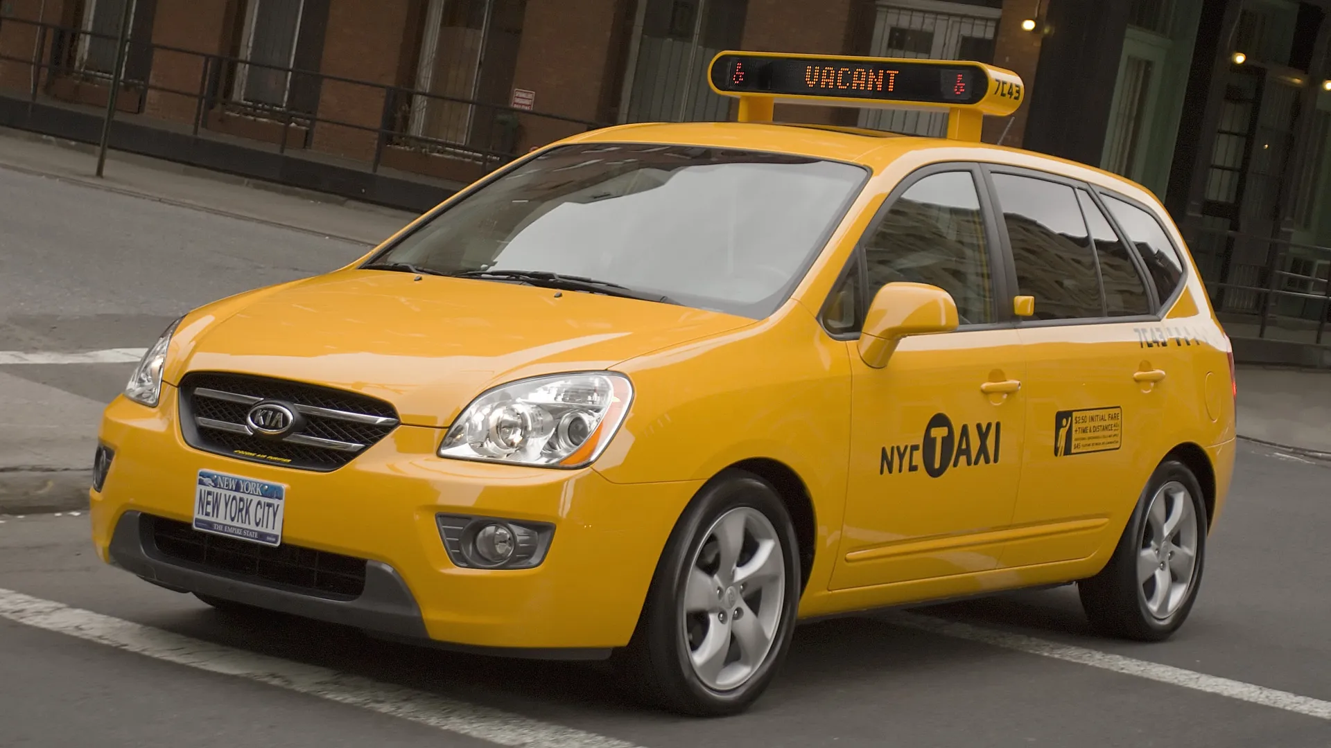 Yellow taxi cab in New York City with a vacant sign.