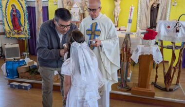 Deline&rsquo;s Danny Bayha offers communion while standing alongside Father Tulio Ramirez, who travelled to the Sahtu community from the Bronx, New York, to preside over Easter mass on April 5. Photo courtesy of Nancy Vail