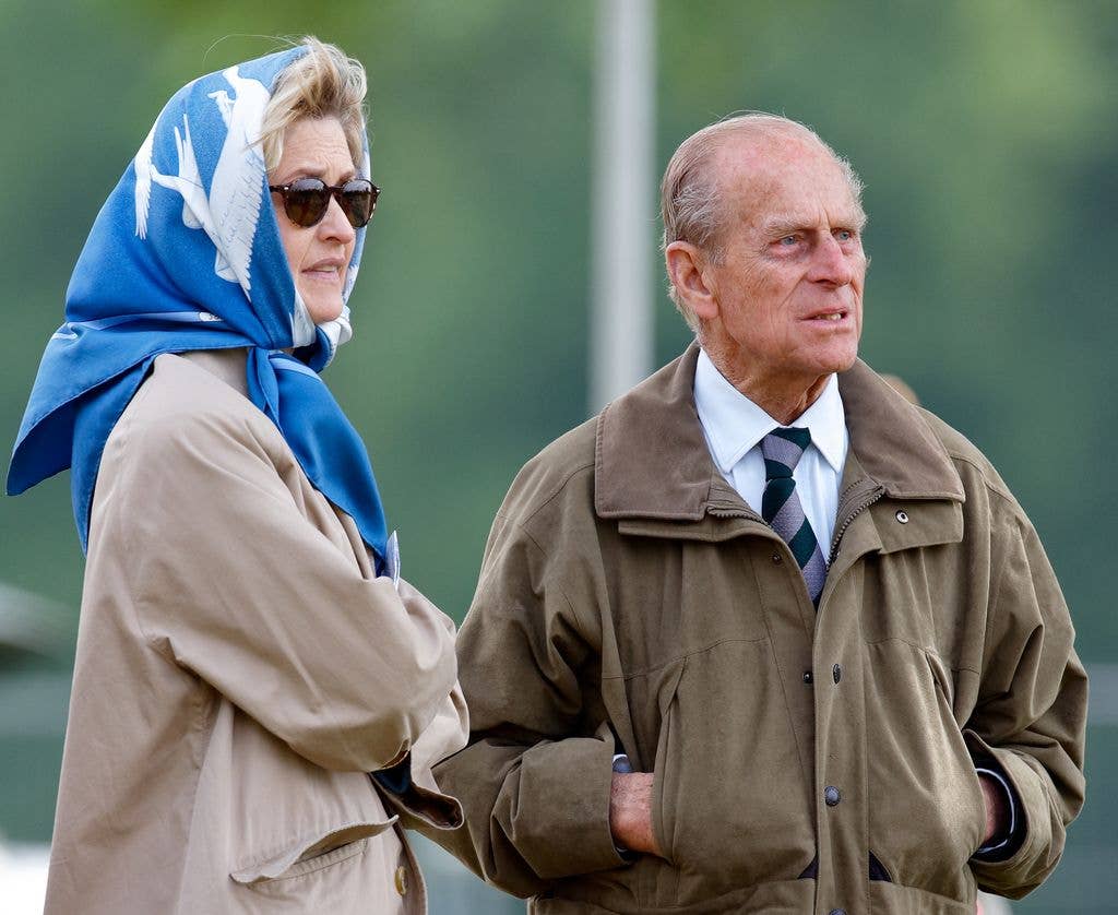 Penelope Knatchbull with scarf on head beside prince Philip outside