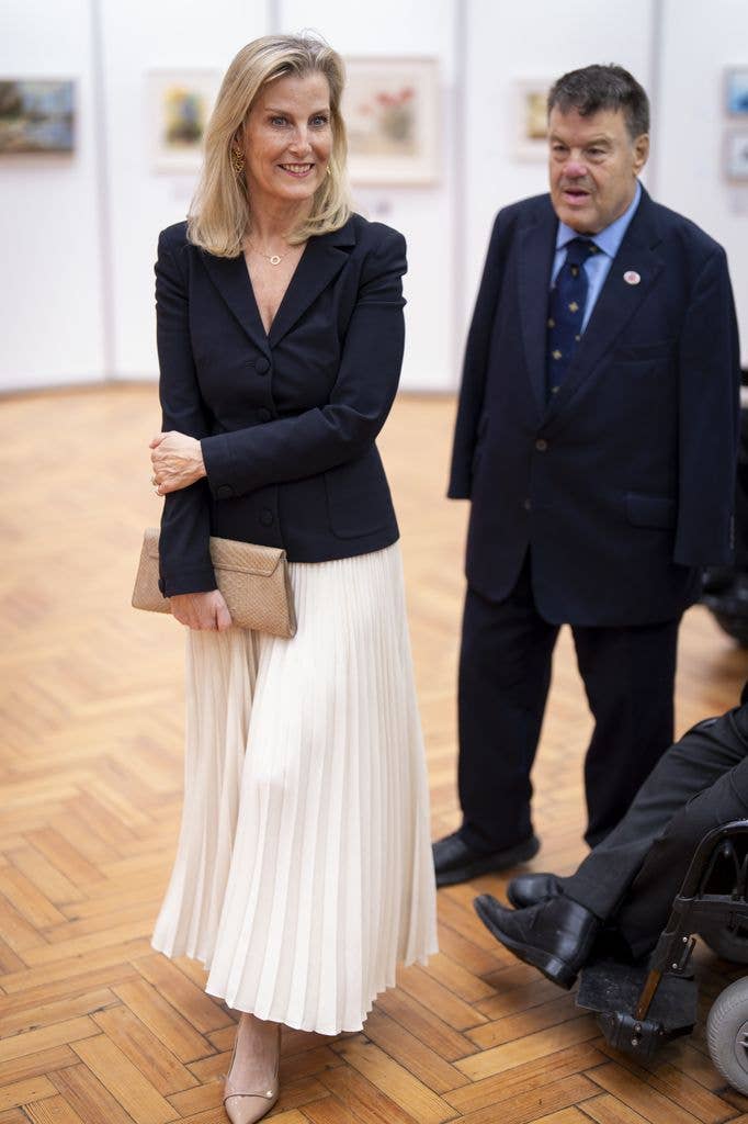 The Duchess of Edinburgh in a black blazer with a pleated white skirt 