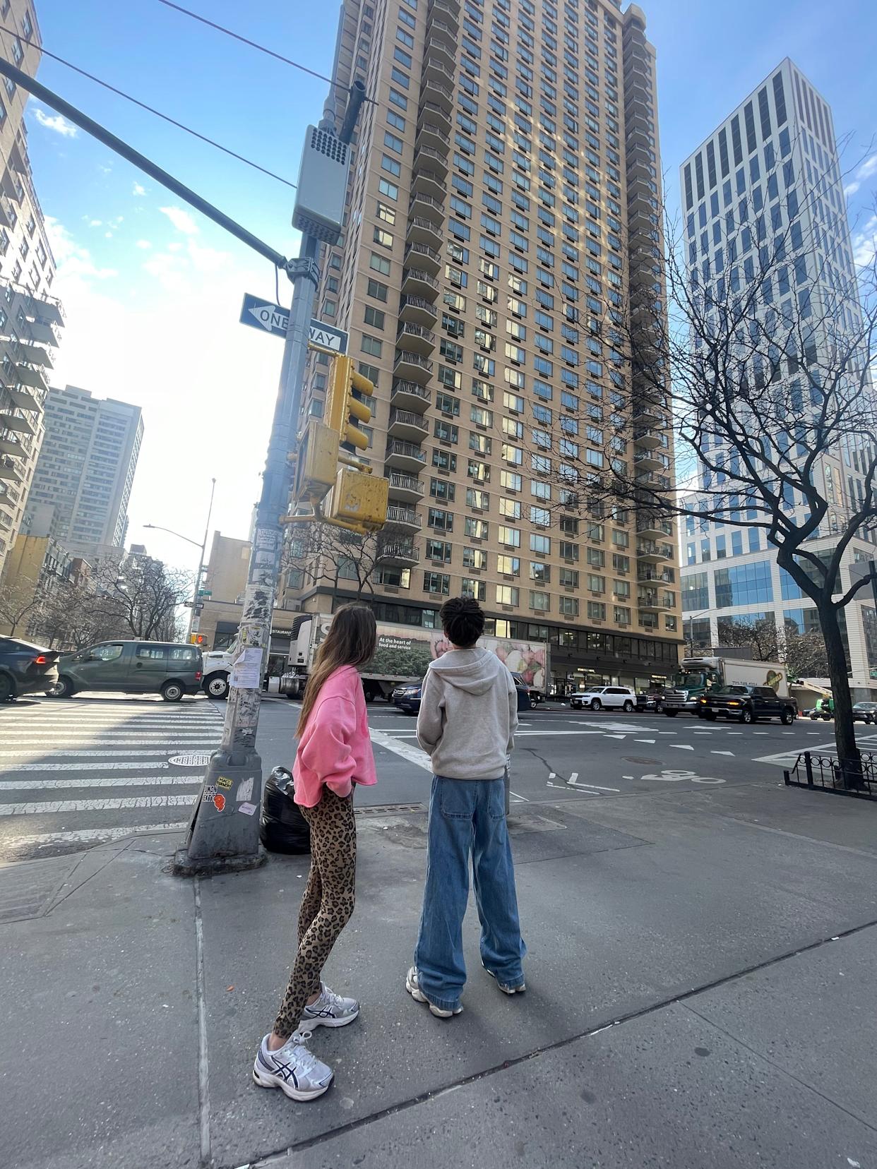 The author's chilcren look up to the apartment they once lived in.