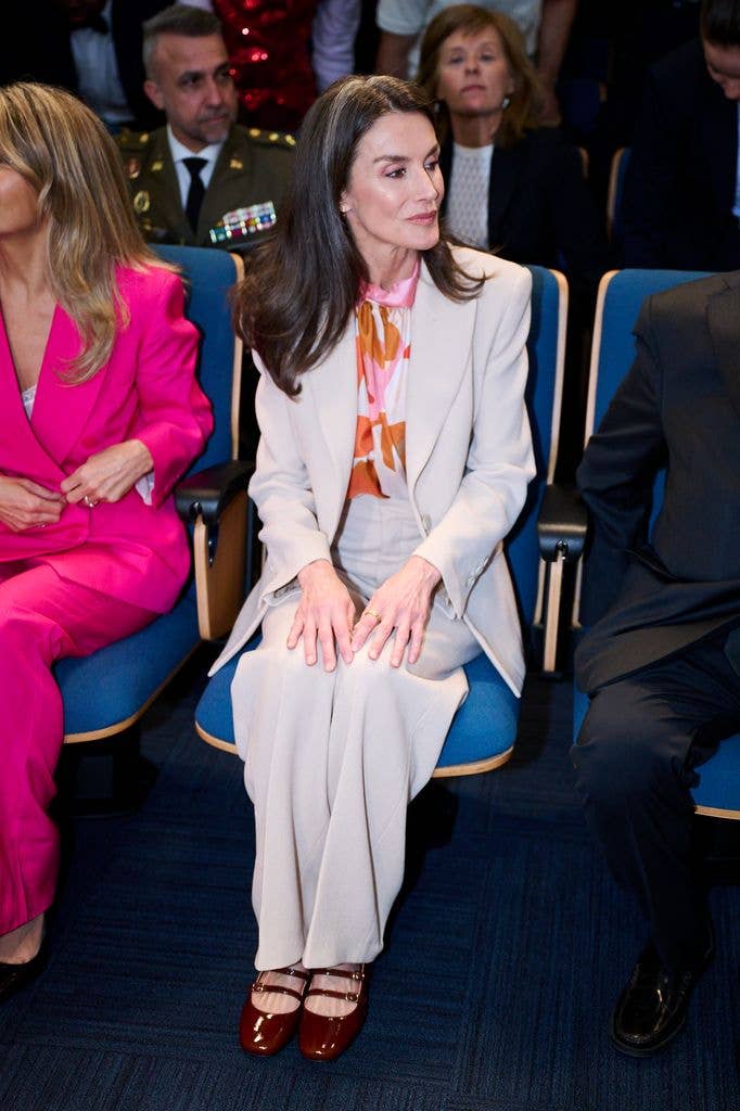  queen letizia of spain seated wearing a cream suit, spring print blouse and sezane shoes