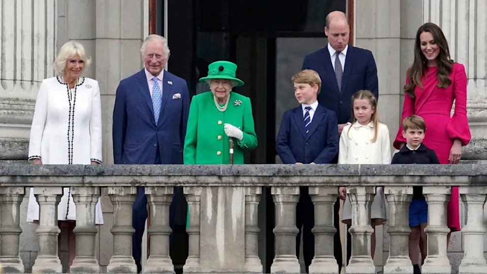 Queen Camilla, King Charles, Queen Elizabeth II, Prince George, Prince William, Princess Charlotte, Prince Louis and Catherine, Princess of Wales stand on the balcony at the Platinum Jubilee Pageant