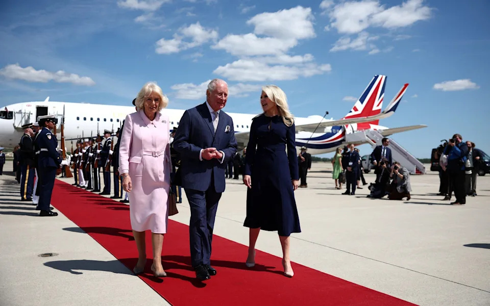 Queen Camilla arrives in a Dior coatdress by British designer Jonathan Anderson, a subtle nod to Melania Trump's favourite label
