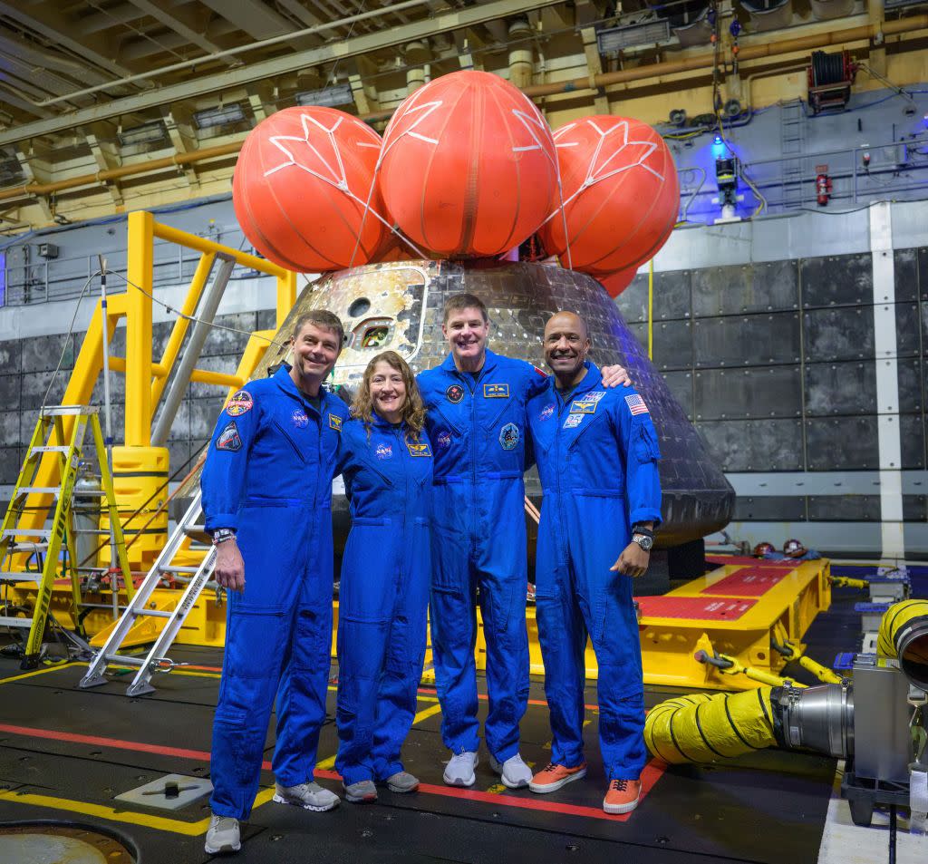The Artemis II crew, consisting of astronauts (from left to right) Reid Wiseman, Christina Koch, Jeremy Hansen, and Victor Glover, pose in front of the Orion spacecraft after their return to Earth. Bill Ingalls/UPI/Shutterstock