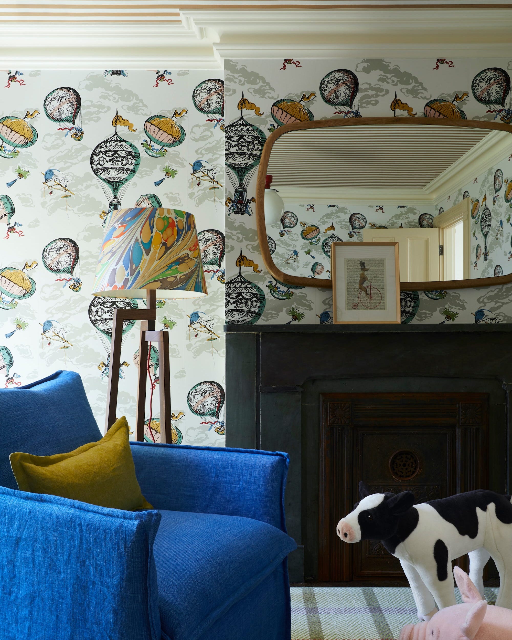 Living room featuring whimsical wallpaper and plush toys.