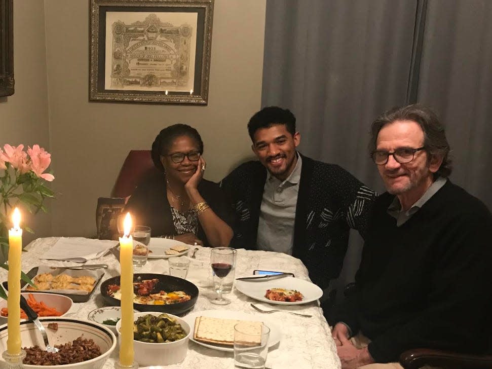 Ciaran Short and his parents at a table in their nyc apartment