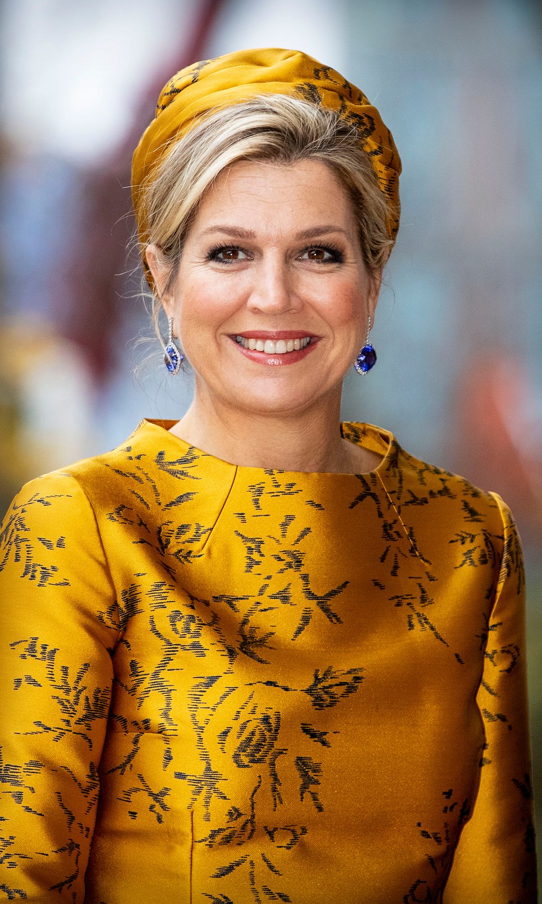Exactly as she did eight years ago, Queen Maxima paired the Natan two-piece with the same suede pumps and matching turban that crowns her chic updo.