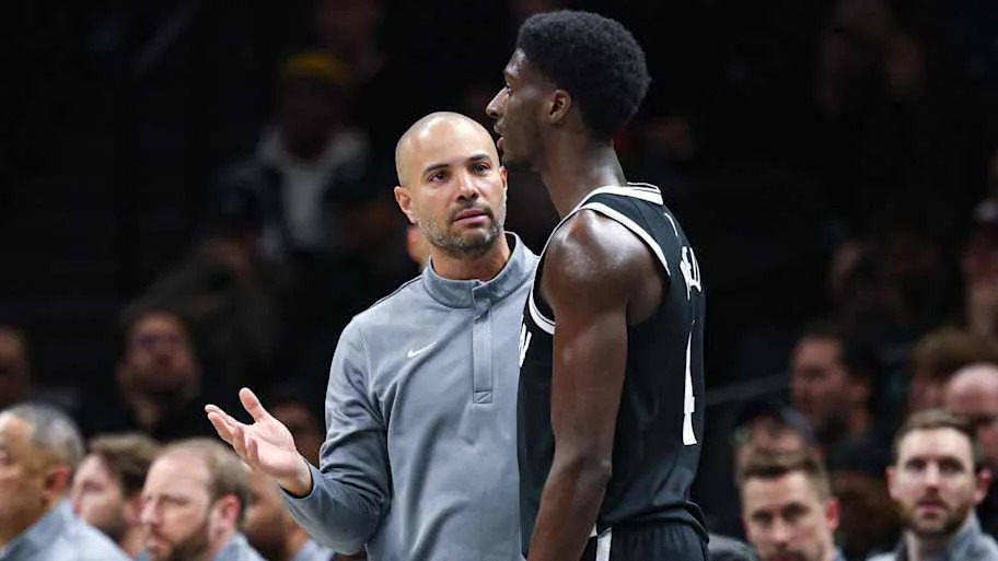 Brooklyn Nets head coach Jordi Fernandez talks with guard Drake Powell (4). Mandatory Credit: Vincent Carchietta-Imagn Images