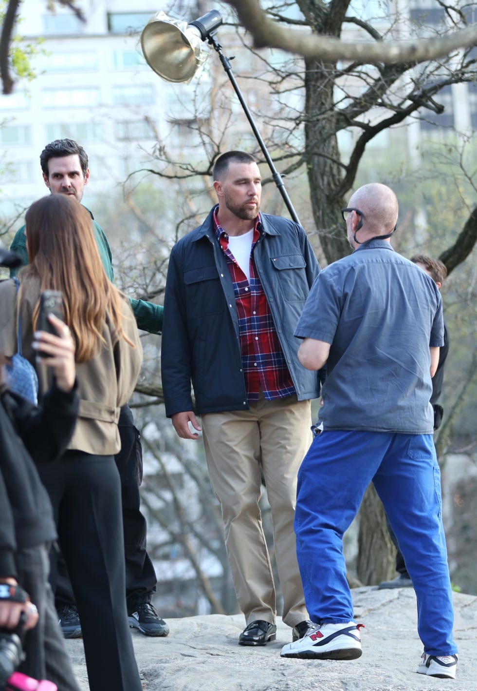Group of people engaging in a photo shoot outdoors.