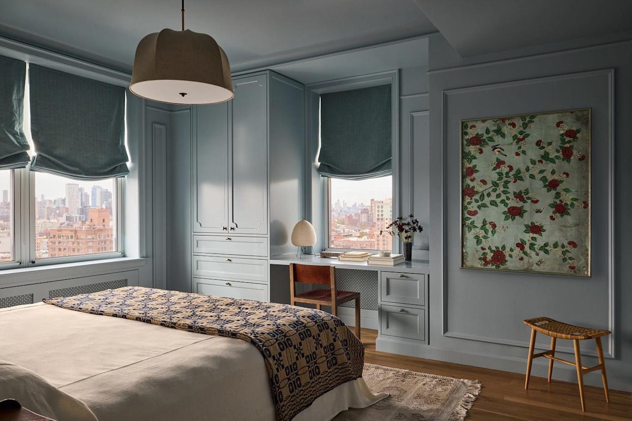 Modern bedroom with natural light and stylistic decor.