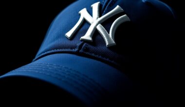 An extreme close-up photograph of the textured navy blue fabric and white stitching of a New York Yankees baseball cap, capturing the luxurious, high-fashion aesthetic of the accessory.