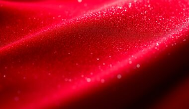 An extreme close-up photograph of a lush, glittering red velvet texture, captured in dramatic studio lighting to create a sense of luxury and glamour.