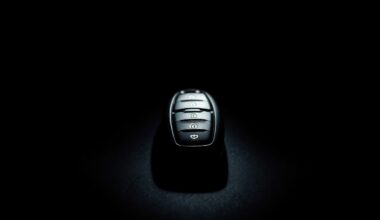 An extreme close-up of a car key fob against a dark background, conceptually illustrating the investigation into a stolen vehicle case.