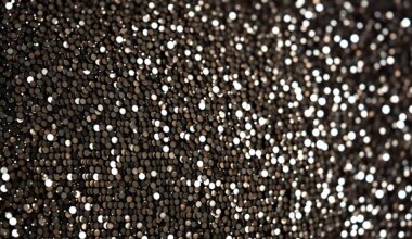 An extreme close-up photograph of a glittering, high-contrast texture such as sequins or crushed velvet, conceptually representing the glamour and celebrity culture surrounding the Beckham family.
