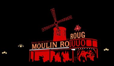 An abstract, minimalist illustration featuring sharp, jagged black silhouettes and geometric shapes in a high-contrast composition, conceptually representing the bold, visually striking nature of the Moulin Rouge! musical on Broadway.