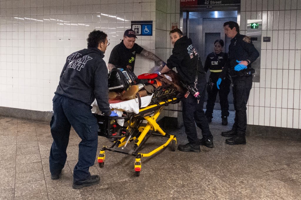 FDNY, NYPD and MTA personnel remove the attacker after he was shot by police, on April 11, 2026. Luiz C. Ribeiro for NY Post