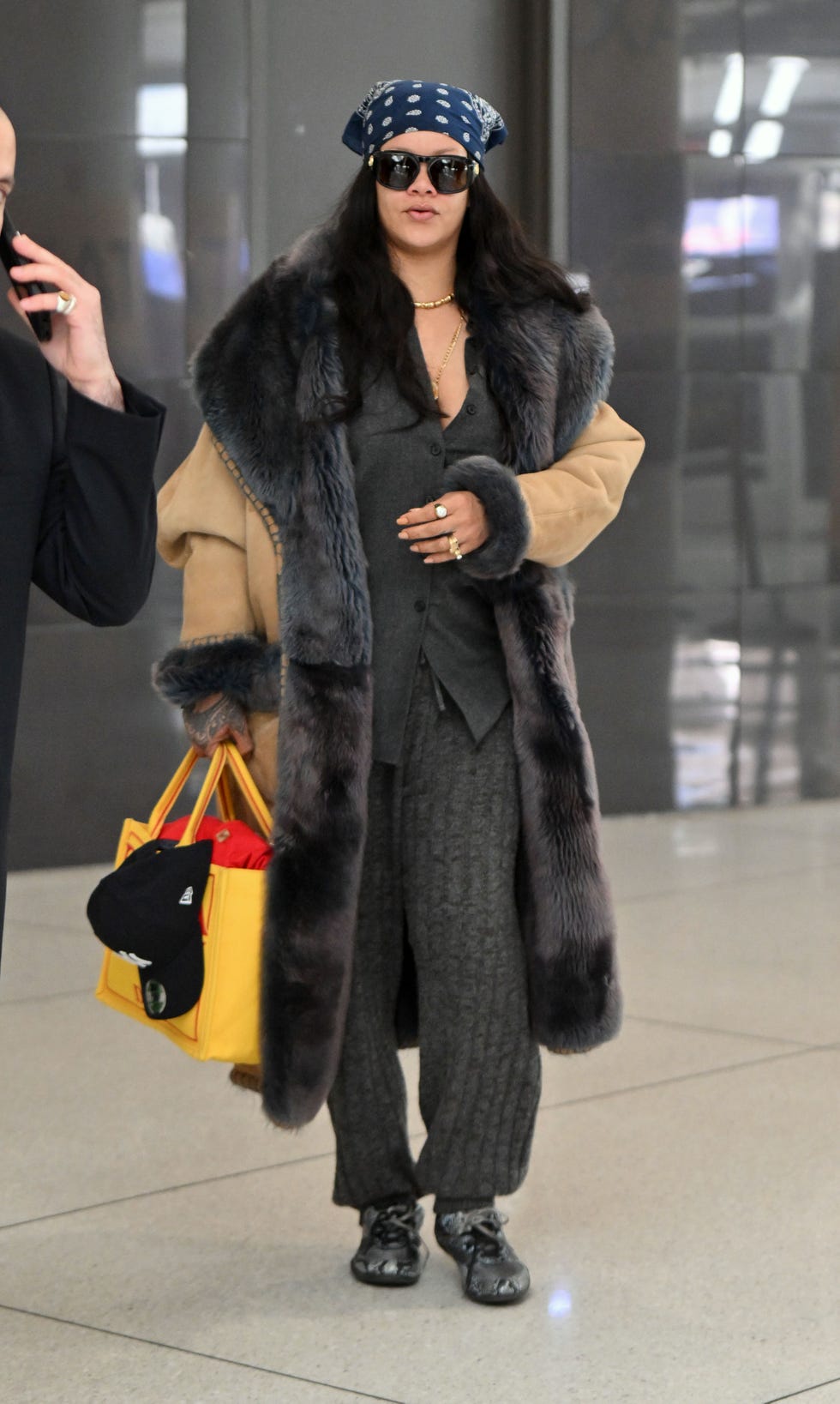 04122026 exclusive rihanna is spotted making a low key arrival into new york city the 38 year old singer and actress wore a fur lined camel coat over a grey top and trousers, bandana, valentino sunglasses and carrying the dior dracula yellow tote bag salestheimagedirectcom please bylinetheimagedirectcomexclusive please email salestheimagedirectcom for fees before use