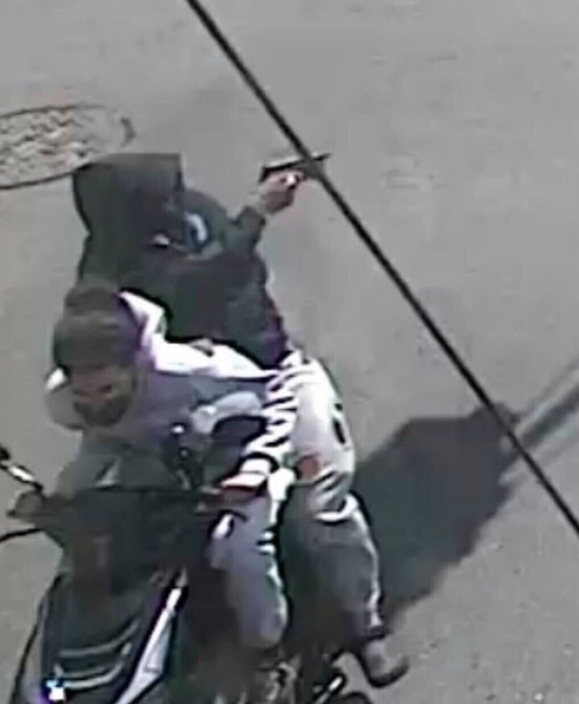 Two moped-riding suspects, one holding a gun.