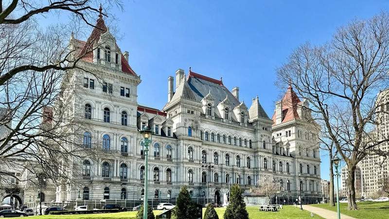 The New York State Capitol stands on a clear spring day with trees and pedestrians in the foreground in Albany, N.Y. Photo: Warren LeMay / Flickr /CC BY-SA 2.0 / Cropped from Original