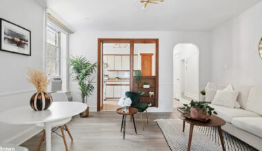 white living and dining area with wood doorway sunset park
