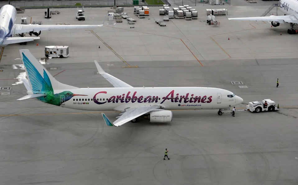 In this photo taken Thursday, Sept. 27, 2012, a Caribbean Airlines jet leaves the gate at Miami International Airport in Miami. (AP Photo/Lynne Sladky)