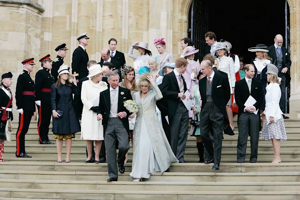 Queen Camilla and King Charles with members of the Royal Family walking down the steps of St George's Chapel at their wedidng