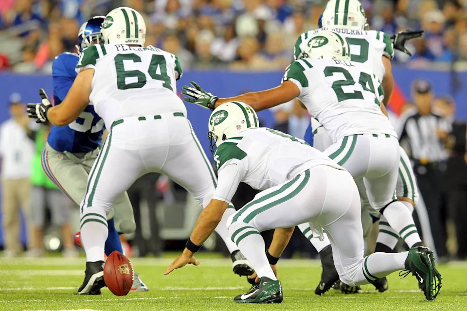 New York Jets quarterback Mark Sanchez fumbles the snap.