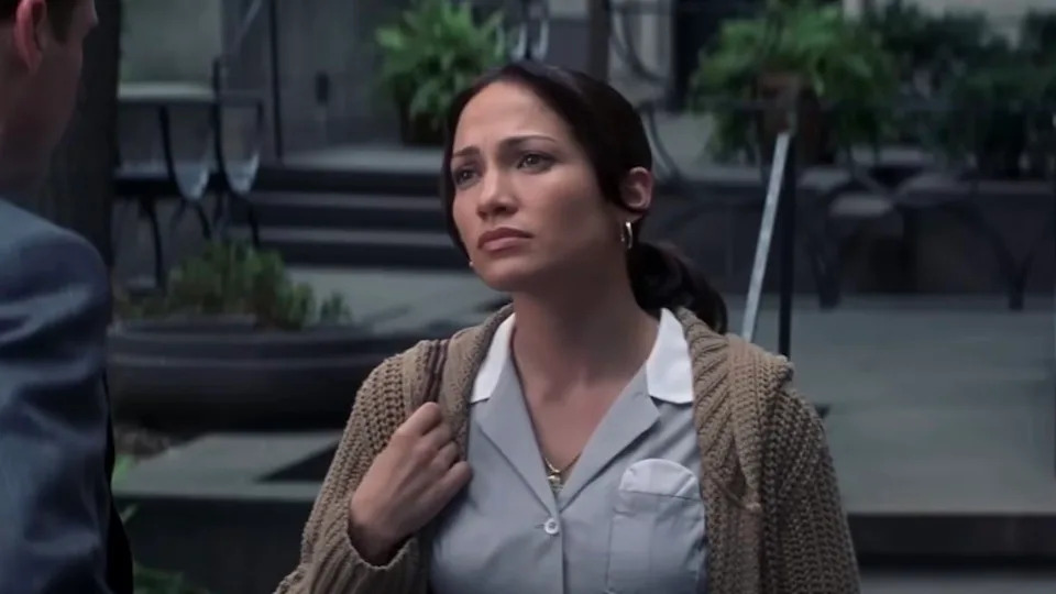 Jennifer Lopez in a maid uniform talking to Ralph Fiennes in Maid in Manhattan.