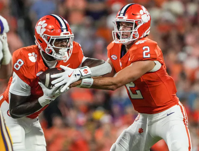Clemson running back Adam Randall (8) takes the handoff from quarterback Cade Klubnik (2) playing LSU during the first quarter at Memorial Stadium in Clemson, S.C. Saturday, August 30, 2025.