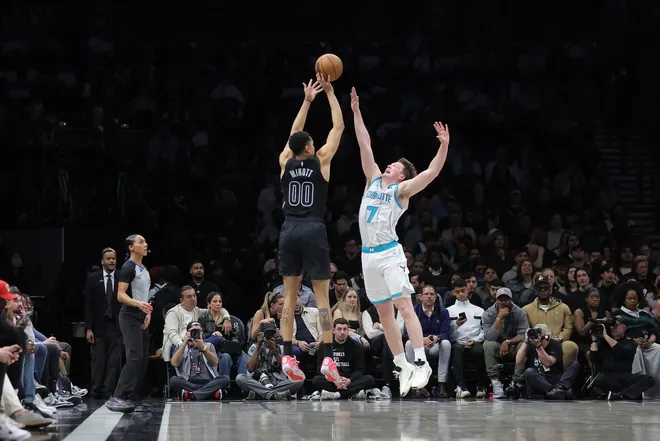 Mar 31, 2026; Brooklyn, New York, USA; Brooklyn Nets forward Josh Minott (00) shoots against Charlotte Hornets guard Kon Knueppel (7) during the third quarter at Barclays Center.