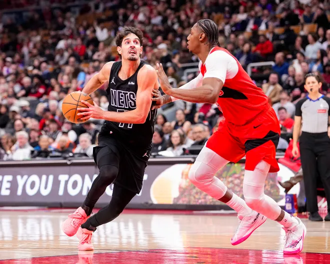 Apr 12, 2026; Toronto, Ontario, CAN; Brooklyn Nets Ben Saraf (77) drives to the basket against Toronto Raptors RJ Barrett (9) during the first half at Scotiabank Arena. Mandatory Credit: Kevin Sousa-Imagn Images